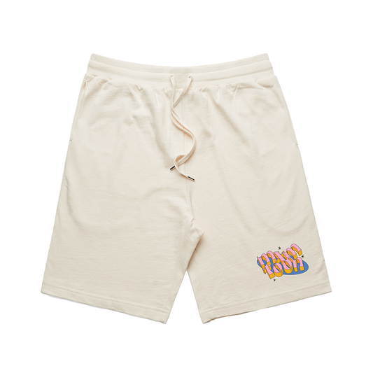 A pair of beige cotton sweat shorts with a drawstring waist and a colorful cartoon character logo on the left leg.